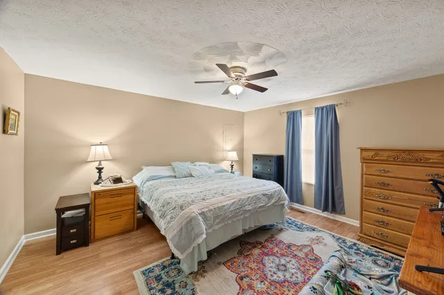 a bedroom with a bed and a chandelier