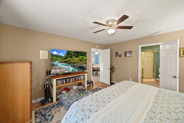 a bedroom with a bed and a flat screen tv