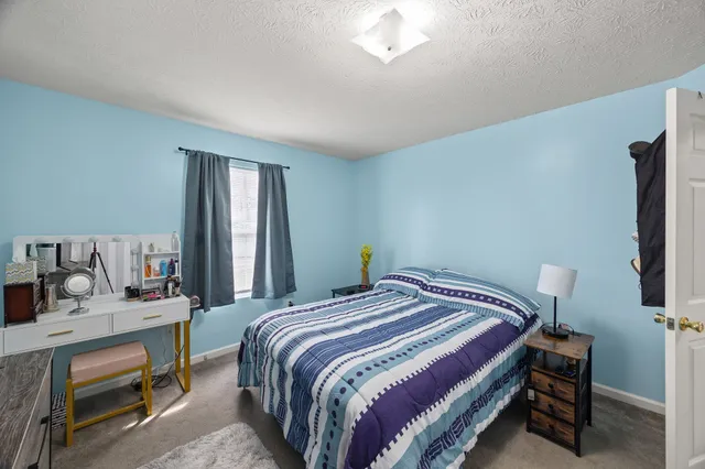 a bedroom with a bed and a dresser in it