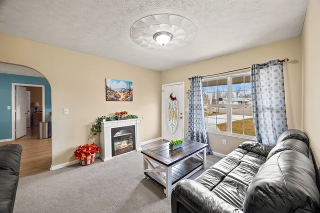 a living room with furniture and a fireplace