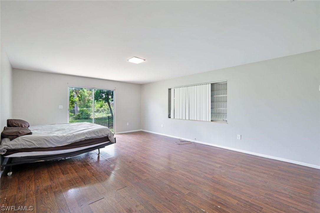 2968 Sunset Road Fort Myers, FL 33901 - Photo 11 of 23 a room with a bed and wooden floor