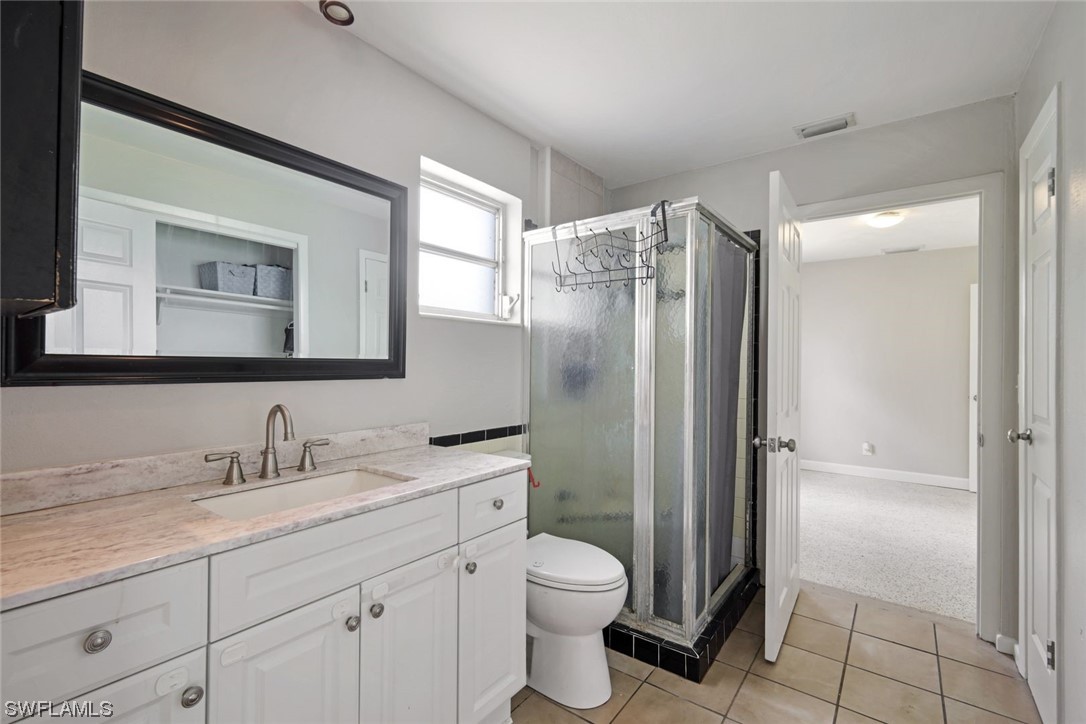 2968 Sunset Road Fort Myers, FL 33901 - Photo 13 of 23 a bathroom with a granite countertop sink toilet and shower