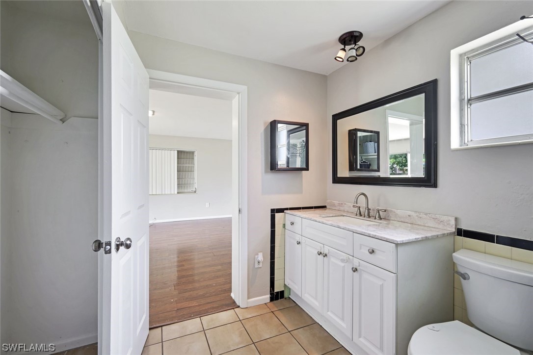 2968 Sunset Road Fort Myers, FL 33901 - Photo 14 of 23 a spacious bathroom with a toilet sink and mirror