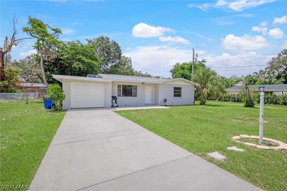 2968 Sunset Road Fort Myers, FL 33901 - Photo 2 of 23 a front view of house with a garden and patio