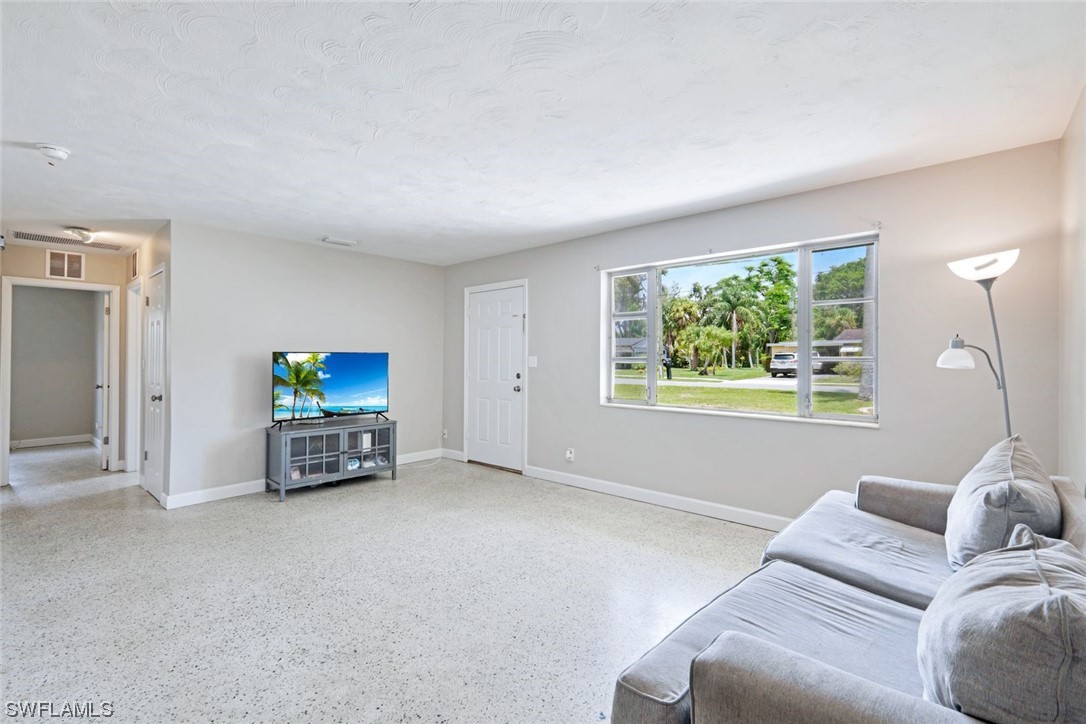 2968 Sunset Road Fort Myers, FL 33901 - Photo 5 of 23 a living room with furniture and a flat screen tv