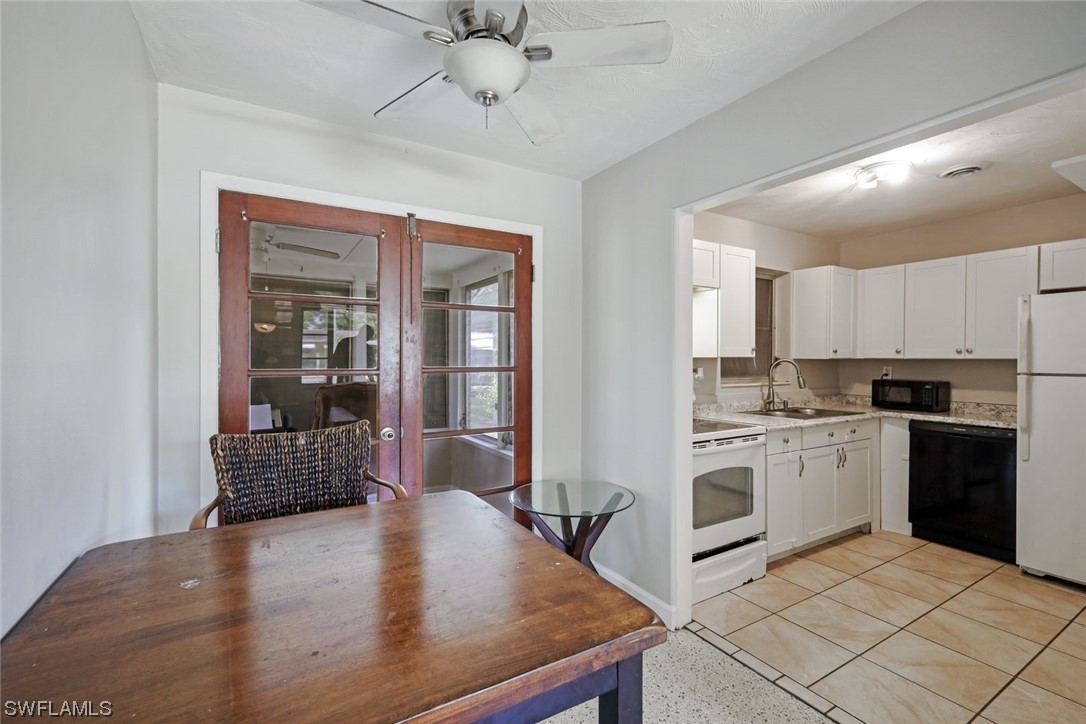 2968 Sunset Road Fort Myers, FL 33901 - Photo 10 of 23 a kitchen with a stove a refrigerator and a sink