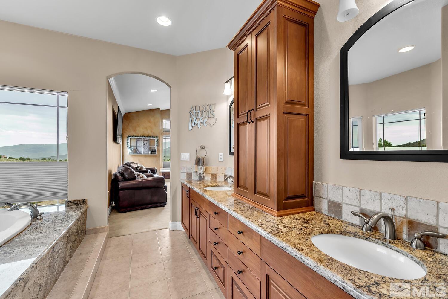 3100 Yellow Tail Road Reno, NV 89510 - Photo 11 of 40 a spacious bathroom with a tub double sink and mirror