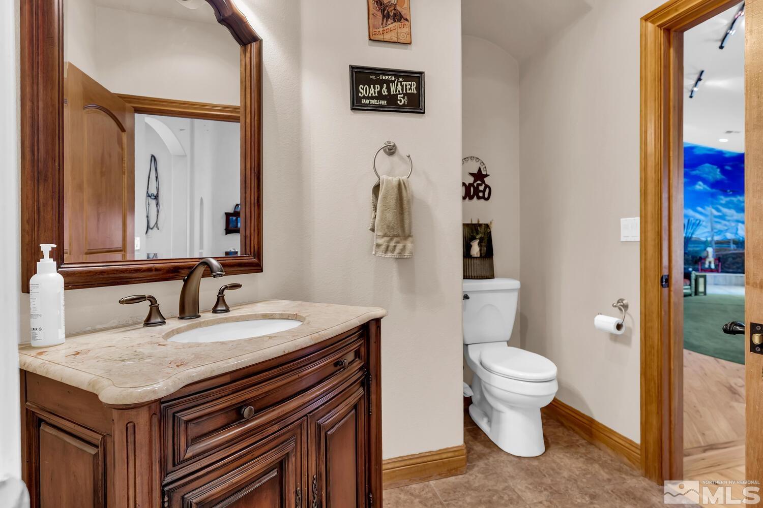 3100 Yellow Tail Road Reno, NV 89510 - Photo 17 of 40 a bathroom with a granite countertop sink a toilet and a mirror