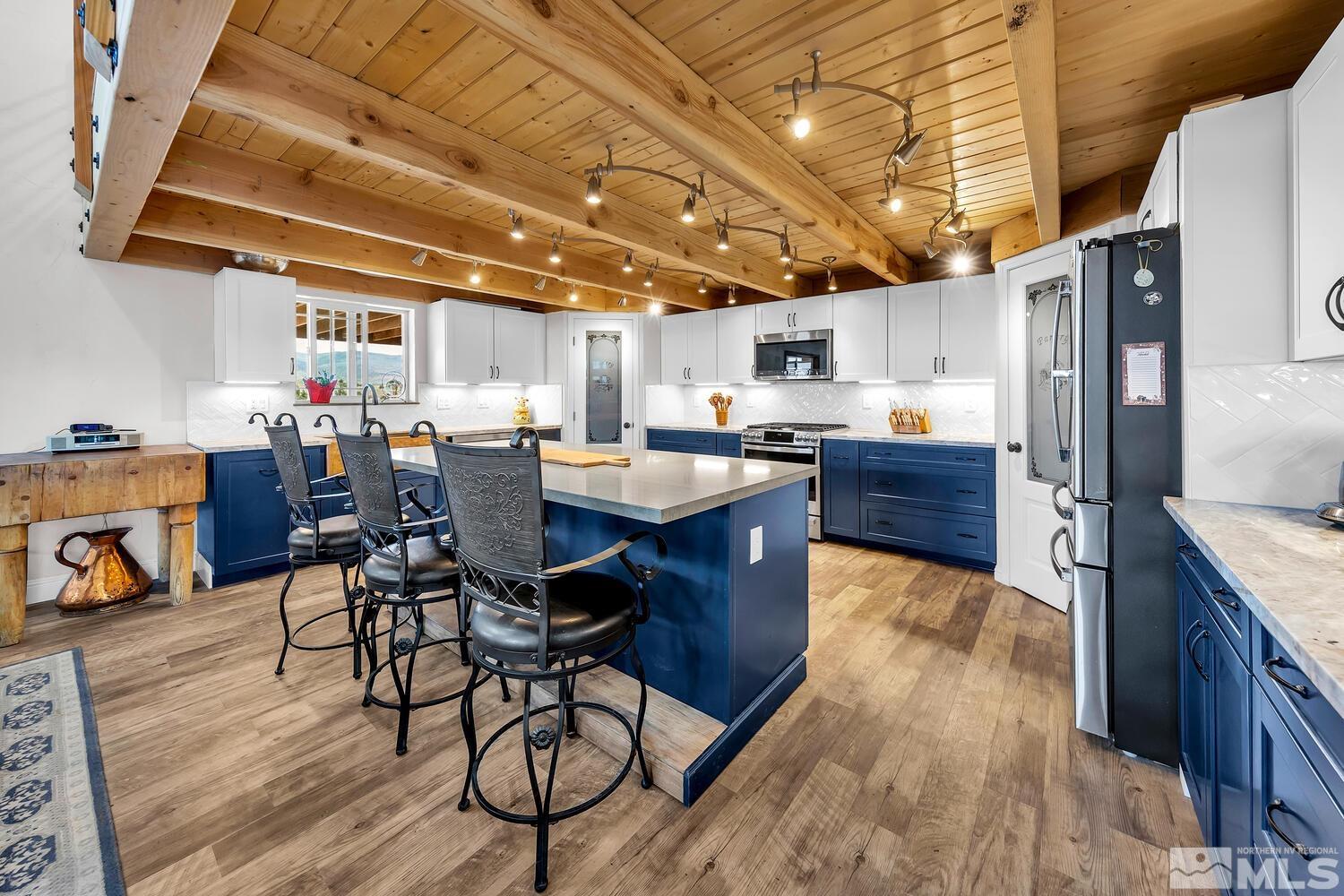 3100 Yellow Tail Road Reno, NV 89510 - Photo 24 of 40 a kitchen with stainless steel appliances wooden floors a sink and a refrigerator