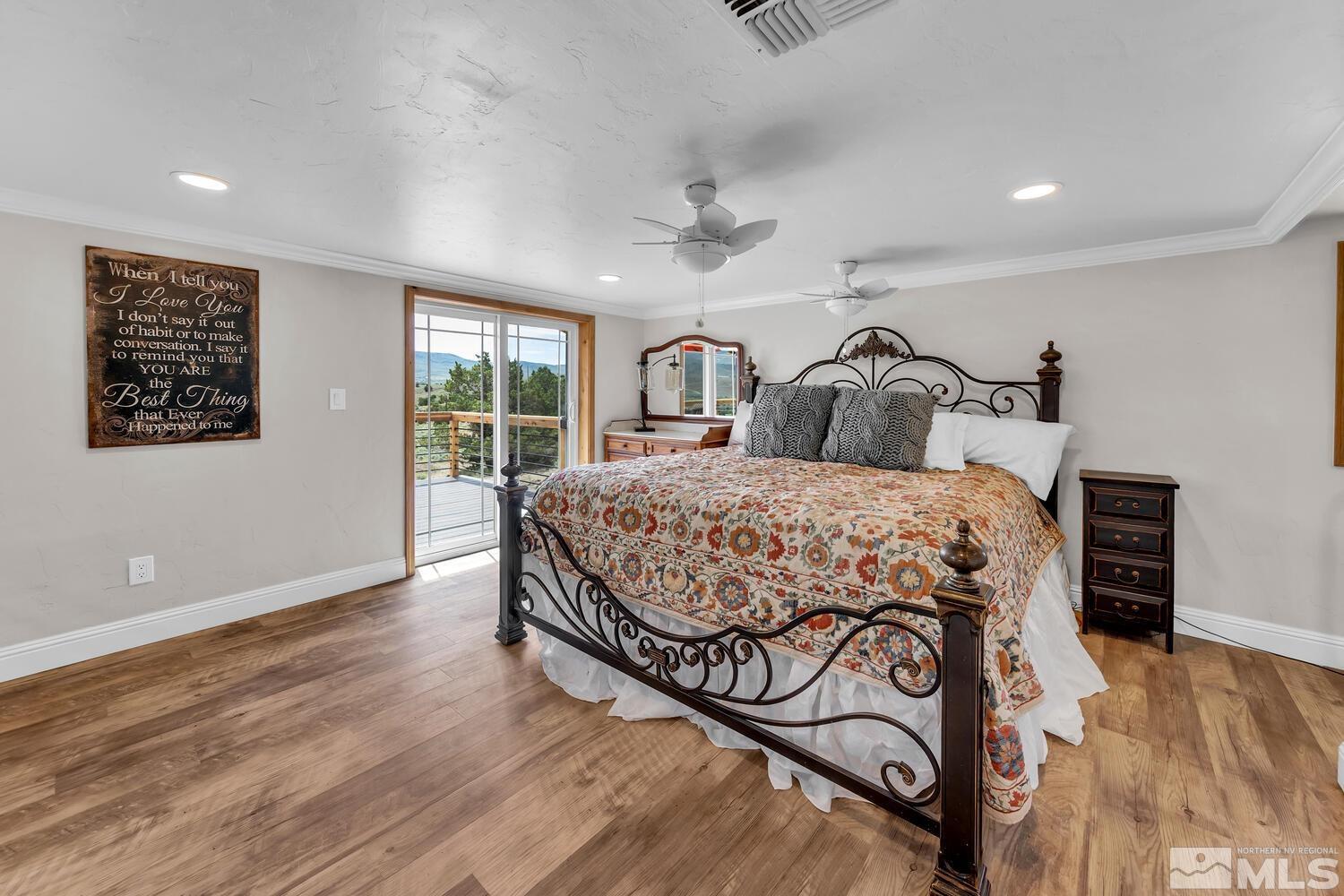 3100 Yellow Tail Road Reno, NV 89510 - Photo 29 of 40 a bedroom with a large bed and a chandelier