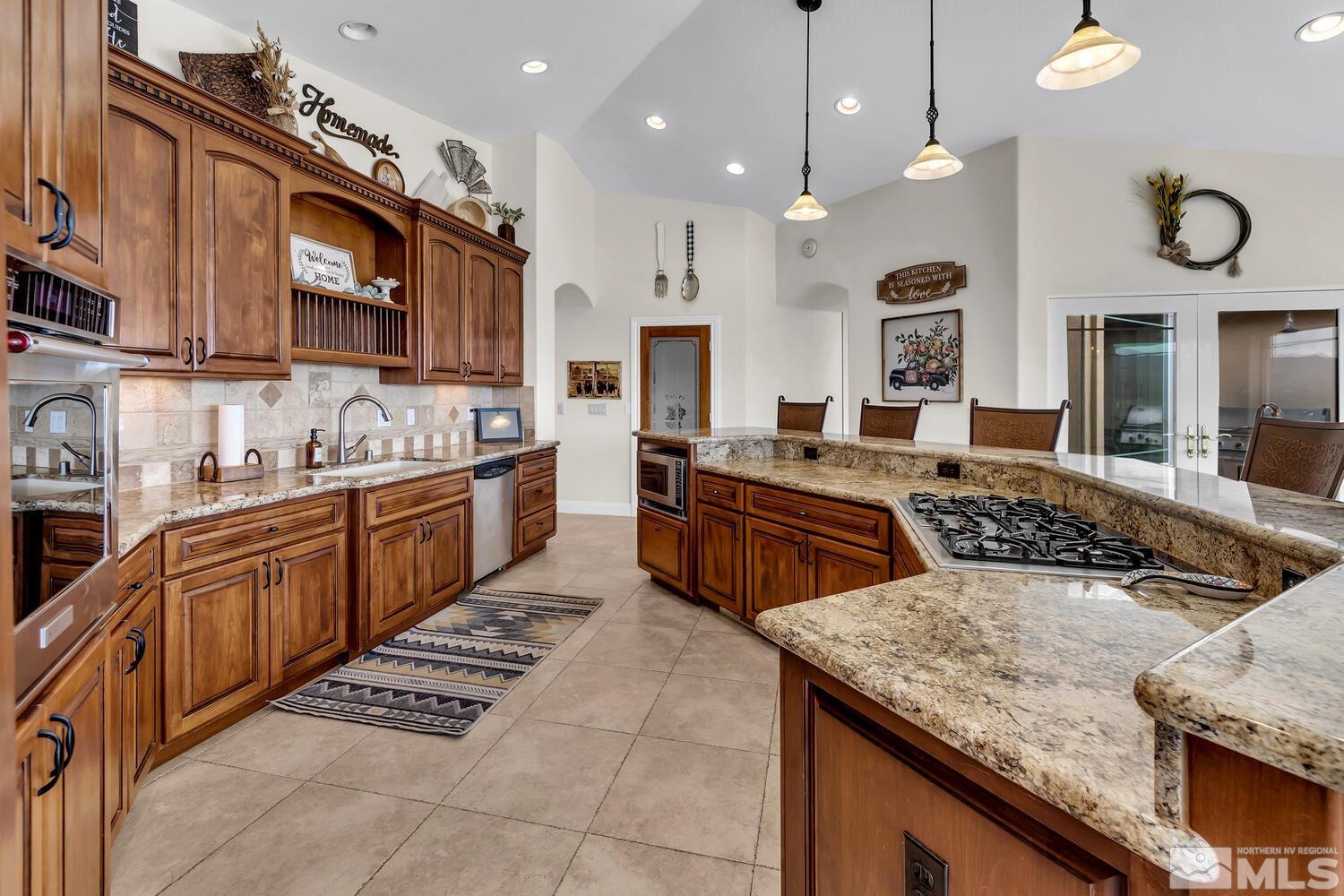3100 Yellow Tail Road Reno, NV 89510 - Photo 7 of 40 a kitchen with stainless steel appliances granite countertop a stove a sink and a microwave