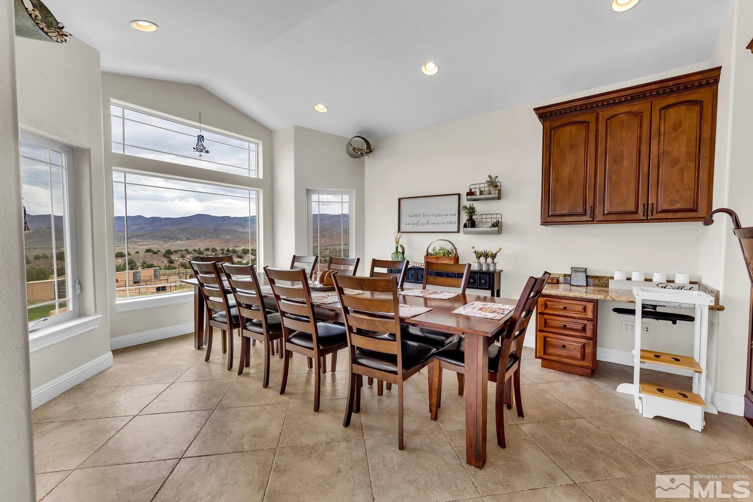 3100 Yellow Tail Road Reno, NV 89510 - Photo 8 of 40 a dining hall with granite countertop a stove a sink a dining table and chairs