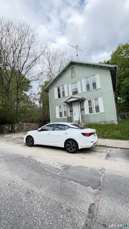 a view of a car parked in front of a house