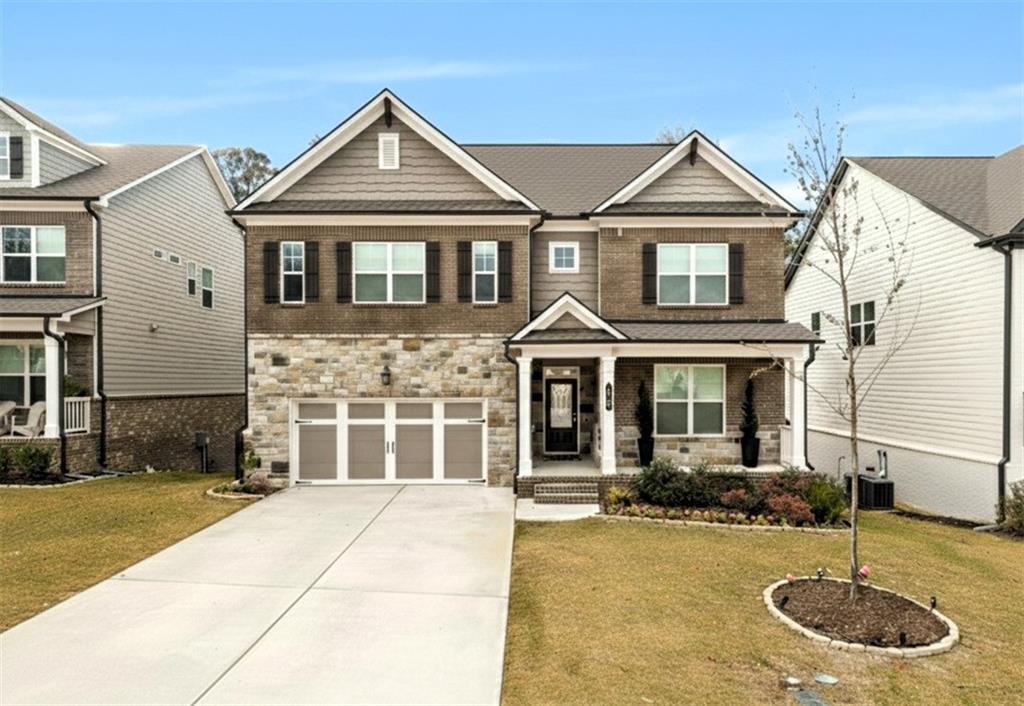 a front view of a house with yard and garage