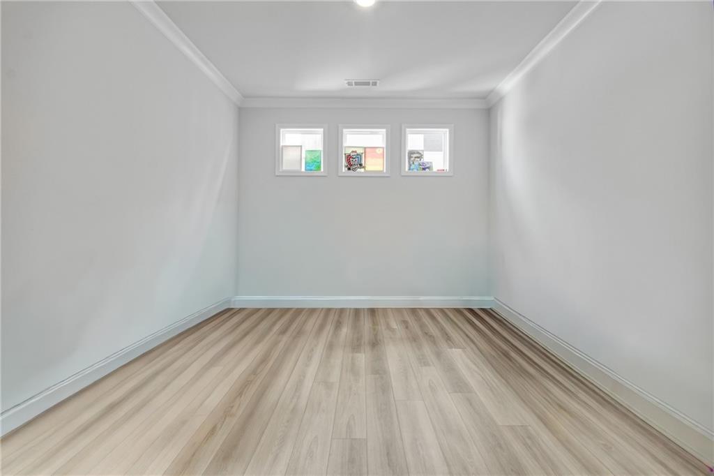 338 Ryston Way Grayson, GA 30017 - Photo 12 of 61 wooden floor in an empty room with a window