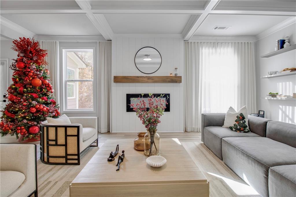 338 Ryston Way Grayson, GA 30017 - Photo 15 of 61 a living room with furniture a potted plant and a chandelier