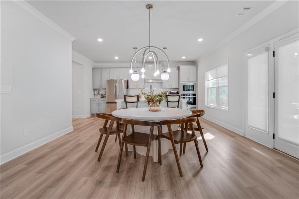338 Ryston Way Grayson, GA 30017 - Photo 16 of 61 a view of a dining room with furniture window and wooden floor