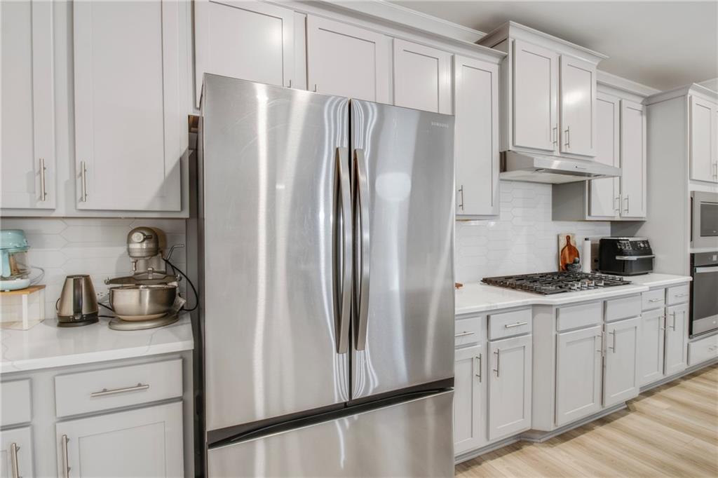 338 Ryston Way Grayson, GA 30017 - Photo 19 of 61 a kitchen with stainless steel appliances a refrigerator sink and cabinets