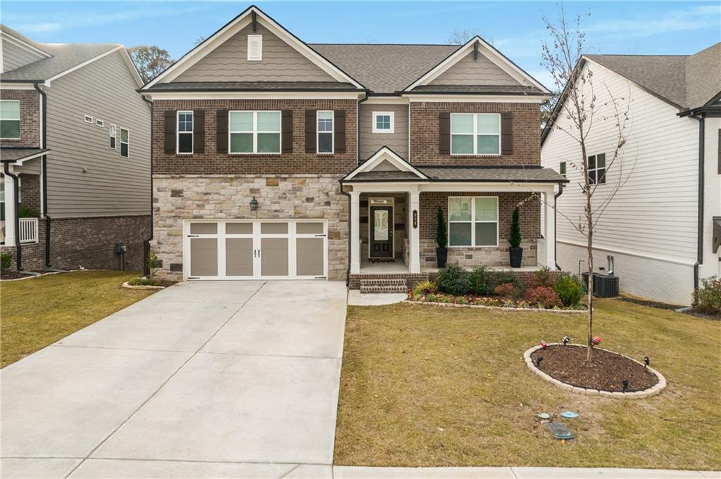 338 Ryston Way Grayson, GA 30017 - Photo 2 of 61 a front view of a house with garden