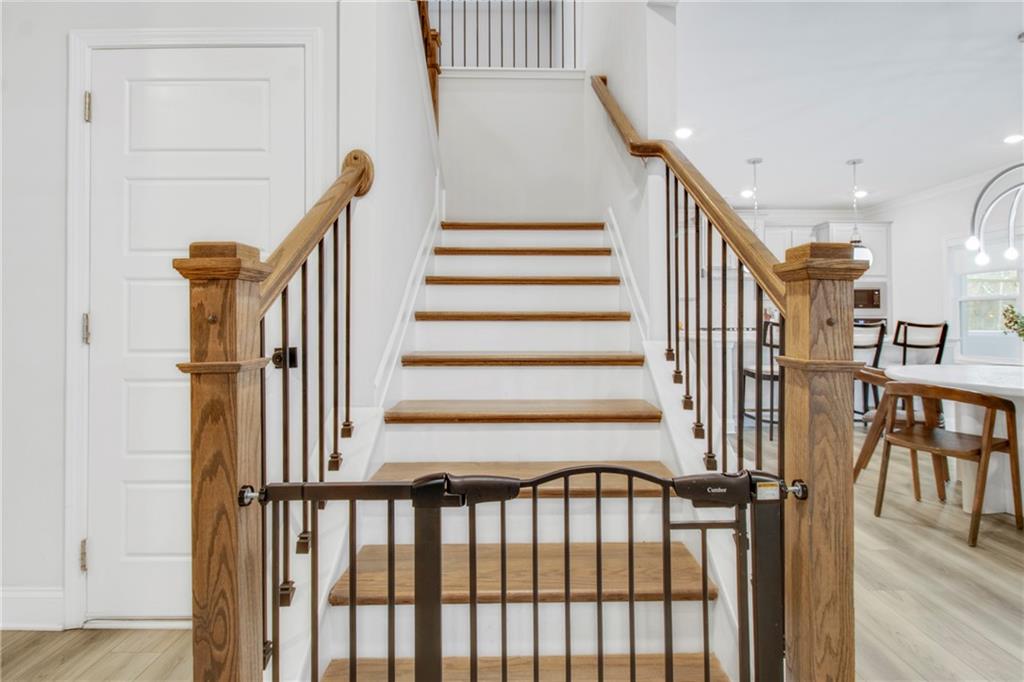 338 Ryston Way Grayson, GA 30017 - Photo 22 of 61 a view of staircase with lots of frames on wall and a window