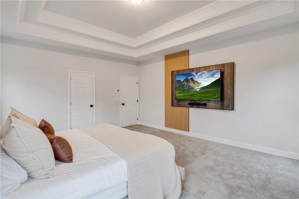 338 Ryston Way Grayson, GA 30017 - Photo 24 of 61 a bedroom with a bed and a painting on the wall