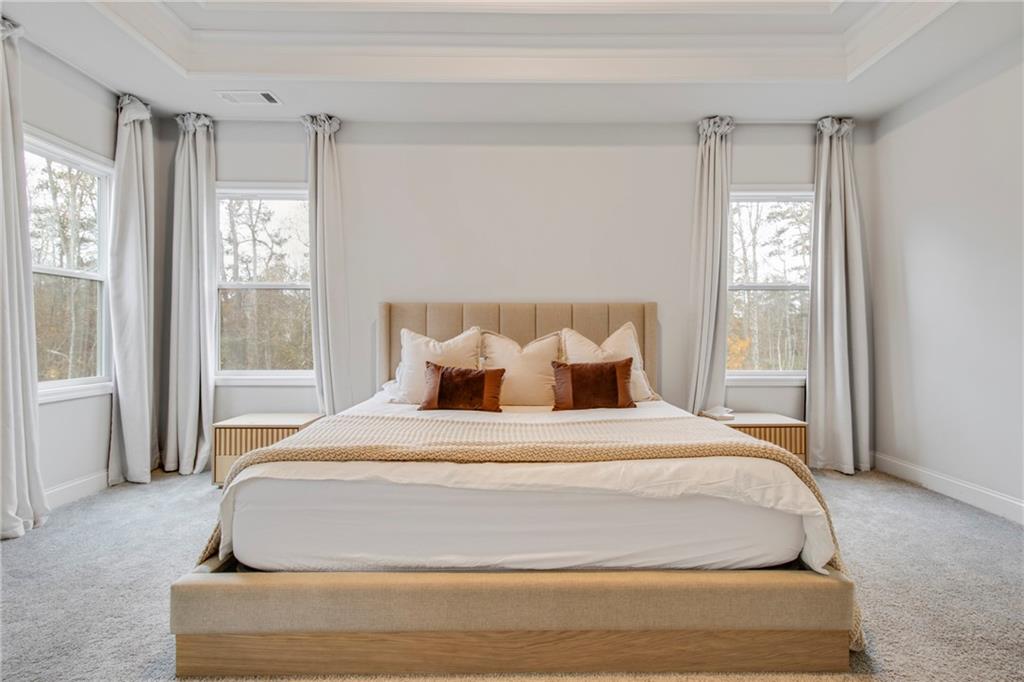 338 Ryston Way Grayson, GA 30017 - Photo 25 of 61 a bedroom with a large bed and a window