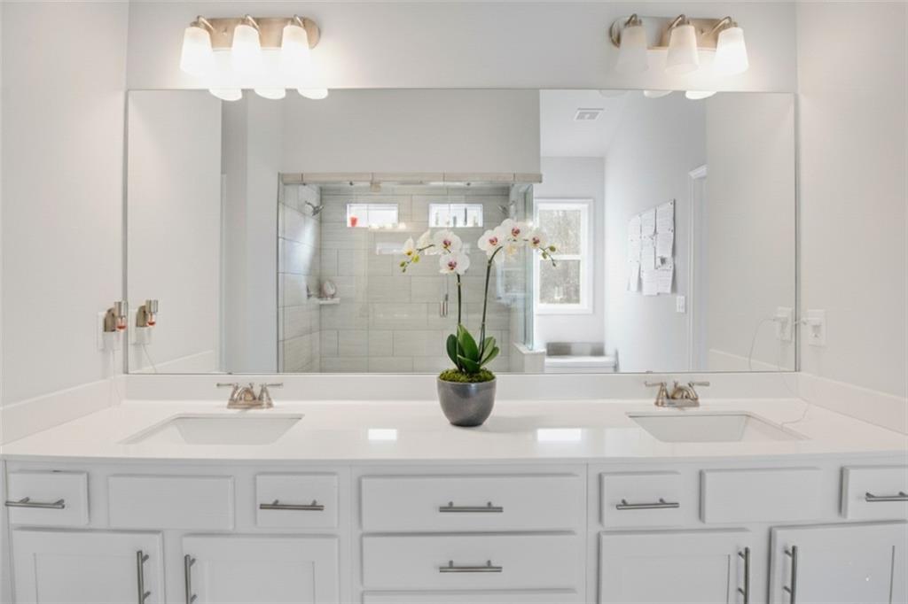 338 Ryston Way Grayson, GA 30017 - Photo 27 of 61 a bathroom with a sink double vanity and a mirror