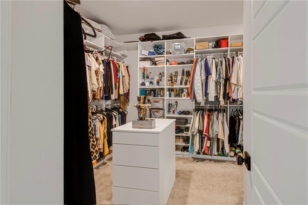 338 Ryston Way Grayson, GA 30017 - Photo 29 of 61 a view of walk in closet with clothes and shoes