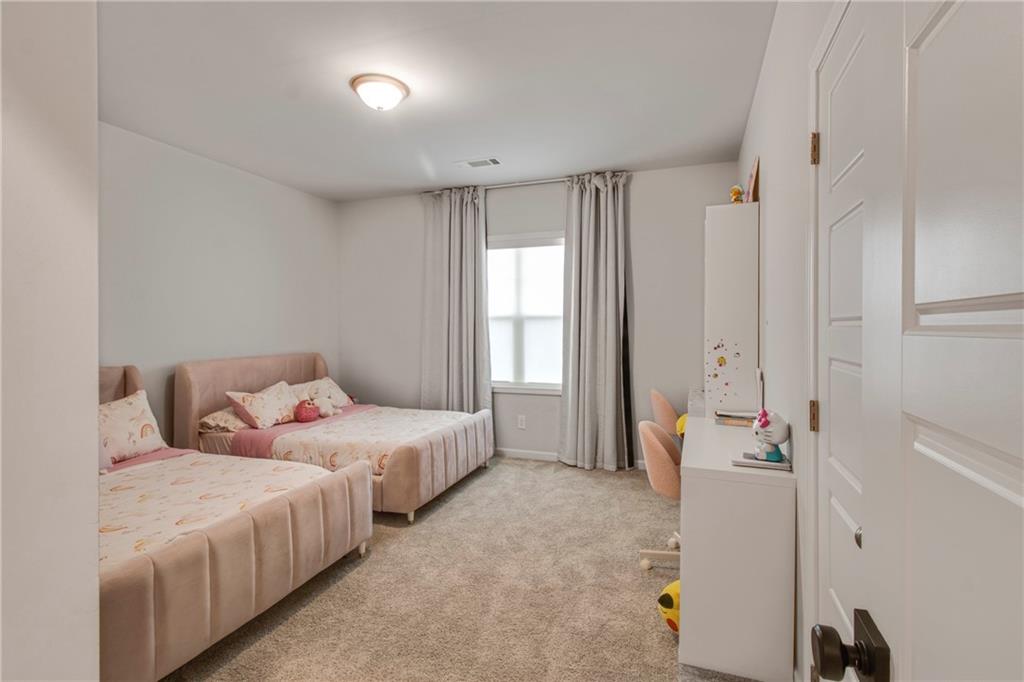 338 Ryston Way Grayson, GA 30017 - Photo 33 of 61 a bedroom with two beds and a window