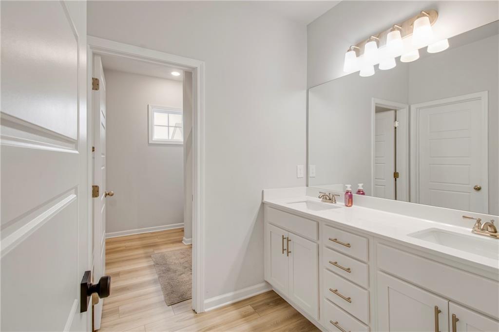 338 Ryston Way Grayson, GA 30017 - Photo 36 of 61 a bathroom with double vanity sink and a mirror