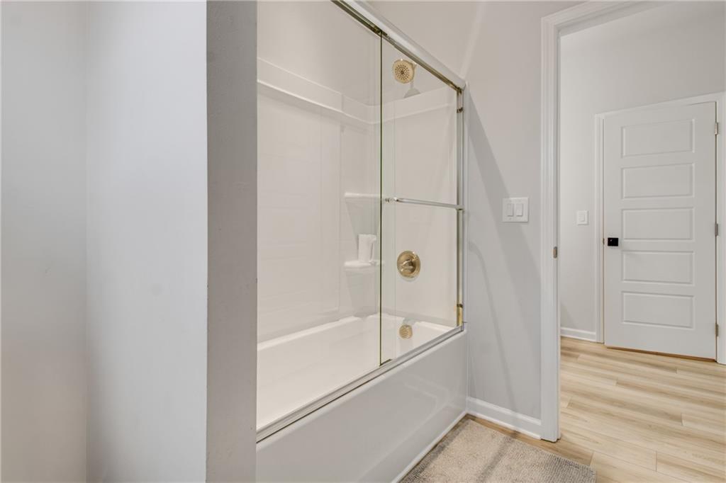 338 Ryston Way Grayson, GA 30017 - Photo 37 of 61 a bathroom with a glass shower door