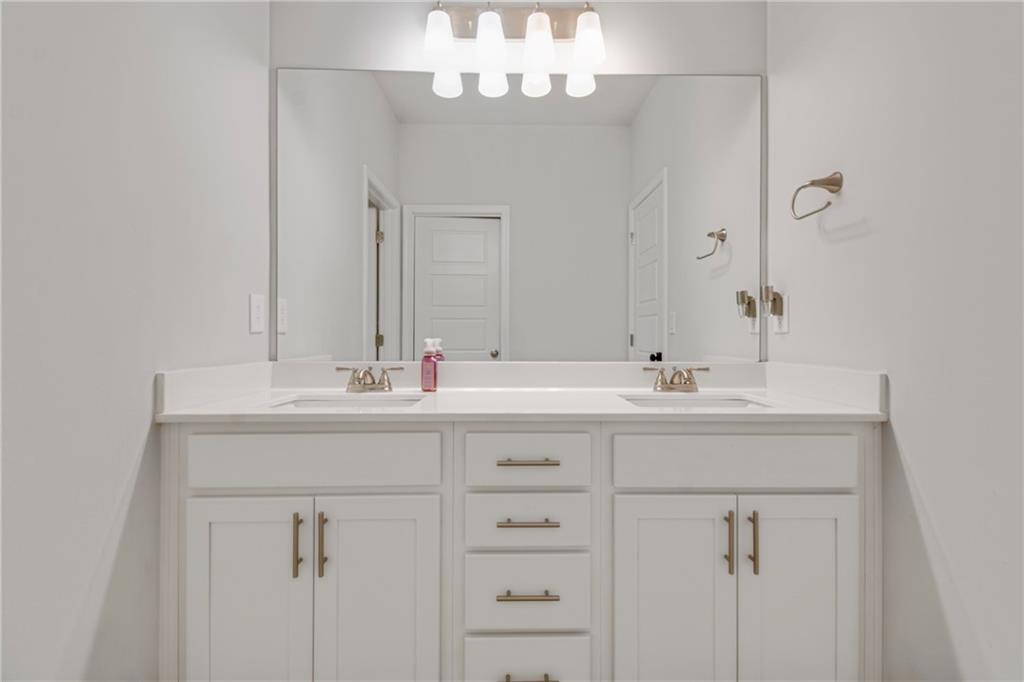 338 Ryston Way Grayson, GA 30017 - Photo 38 of 61 a bathroom with a sink vanity and a mirror