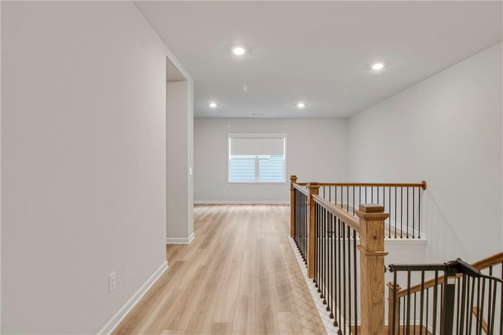 338 Ryston Way Grayson, GA 30017 - Photo 44 of 61 a view of a hallway with wooden floor and staircase
