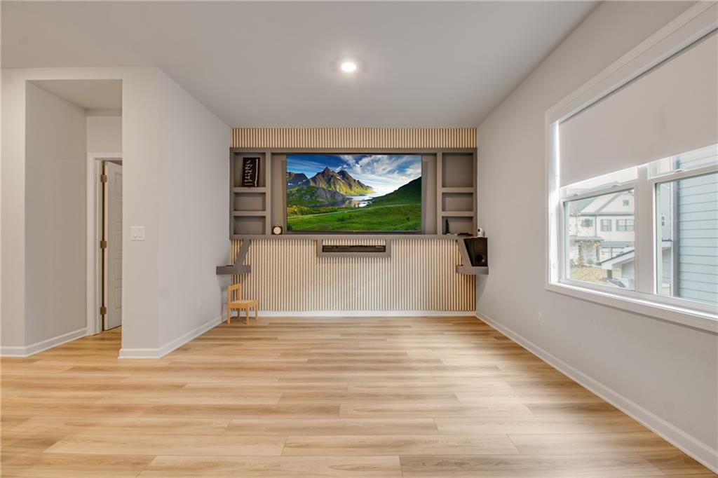 338 Ryston Way Grayson, GA 30017 - Photo 45 of 61 an empty room with wooden floor and windows
