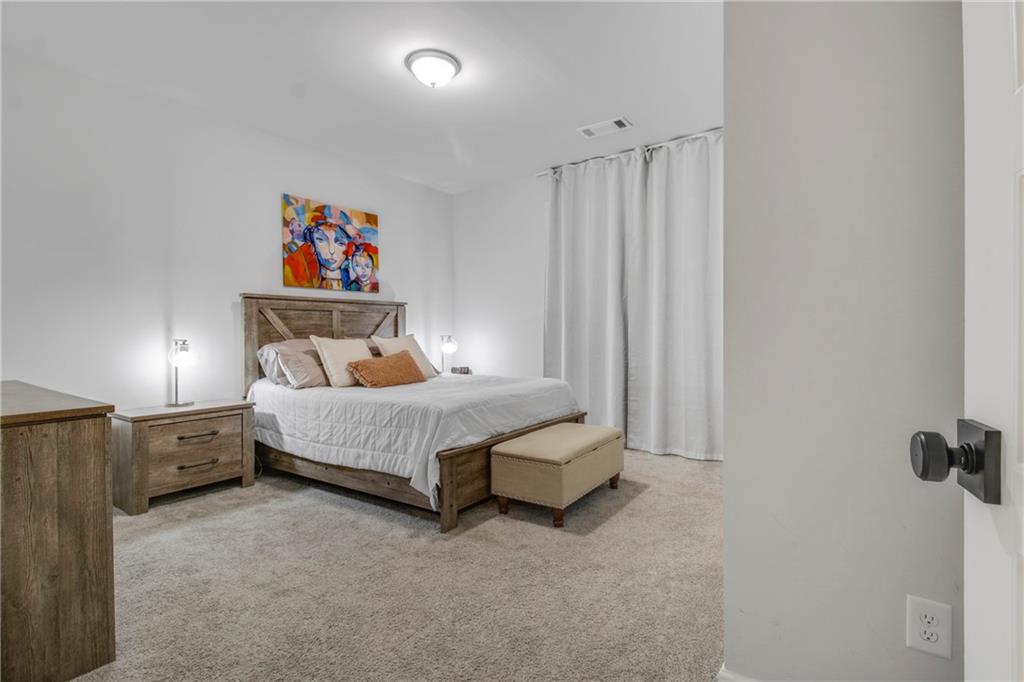 338 Ryston Way Grayson, GA 30017 - Photo 6 of 61 a bedroom with a bed and a painting on the wall