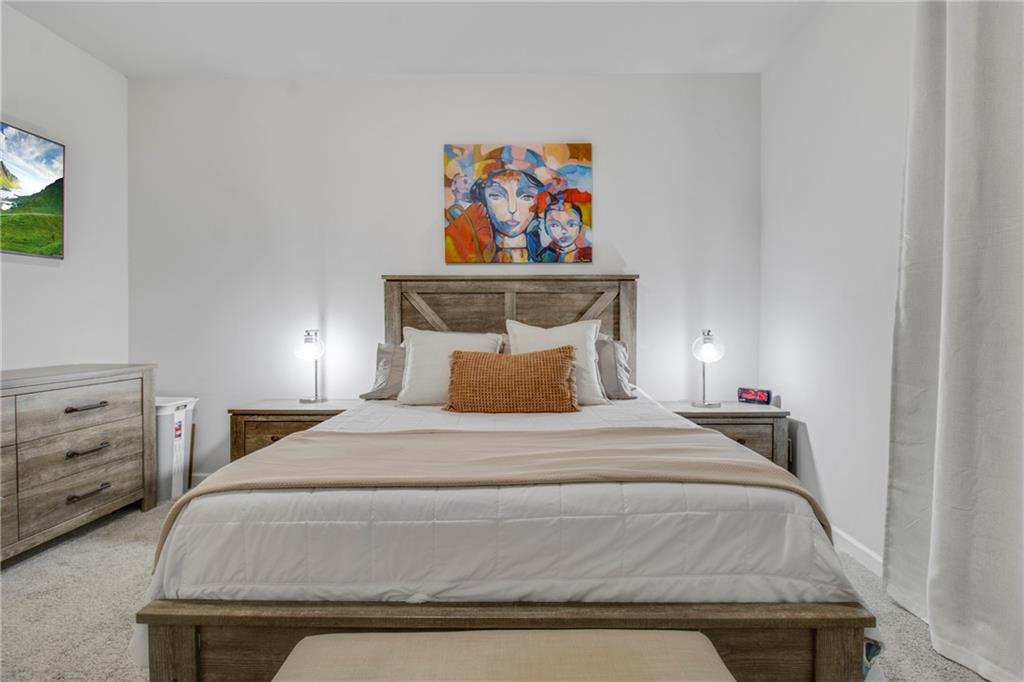 338 Ryston Way Grayson, GA 30017 - Photo 7 of 61 a bedroom with a bed and a painting on the wall