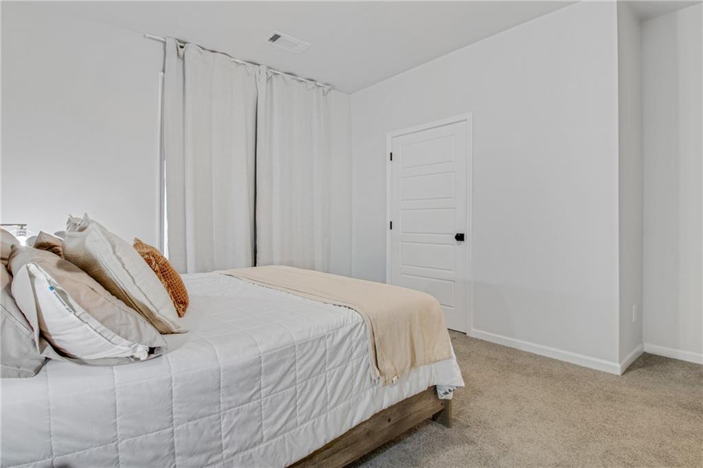 338 Ryston Way Grayson, GA 30017 - Photo 9 of 61 a bedroom with a bed and a window