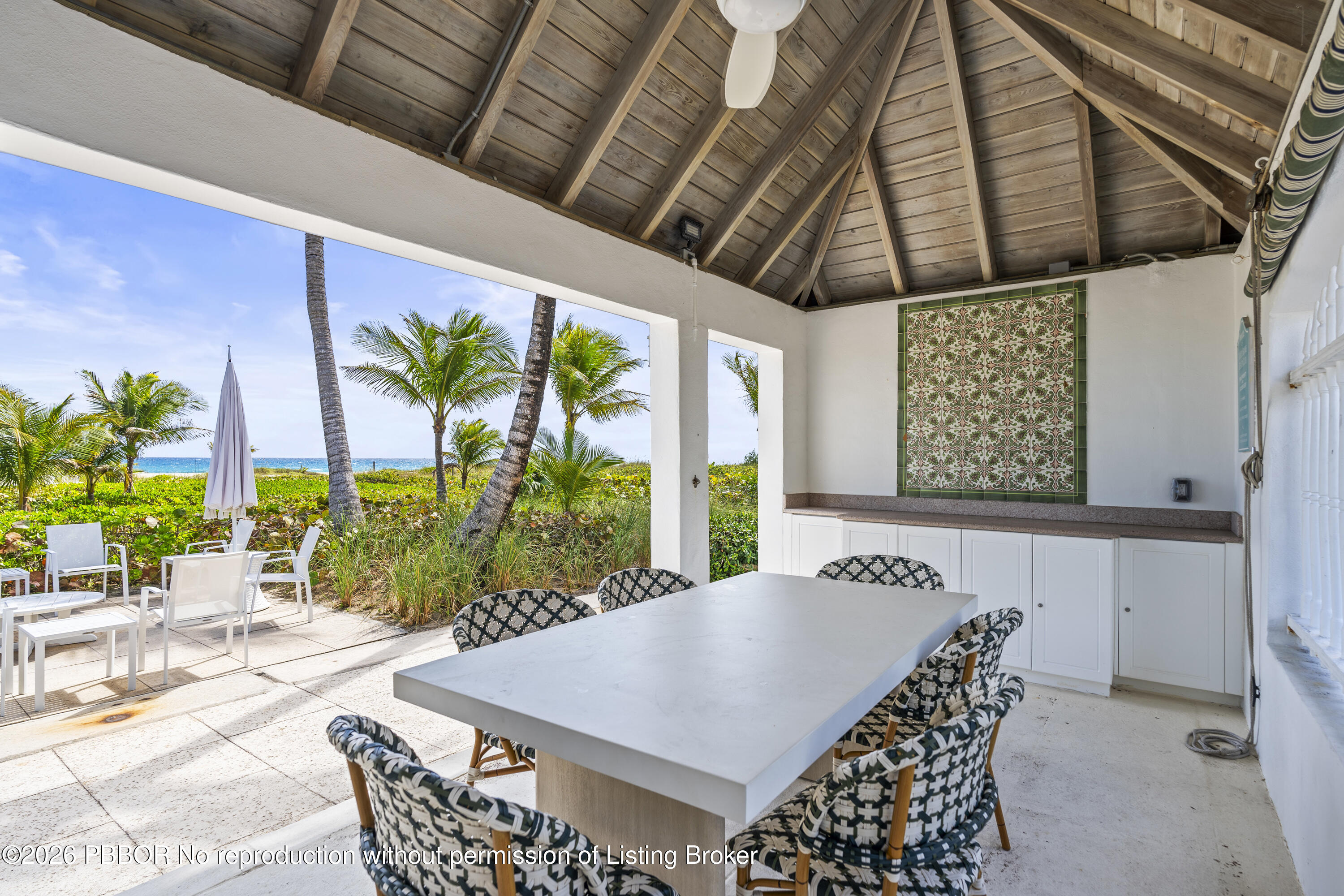 156 Dolphin Road Palm Beach, FL 33480 - Photo 17 of 21 a view of a dining table and chairs in patio