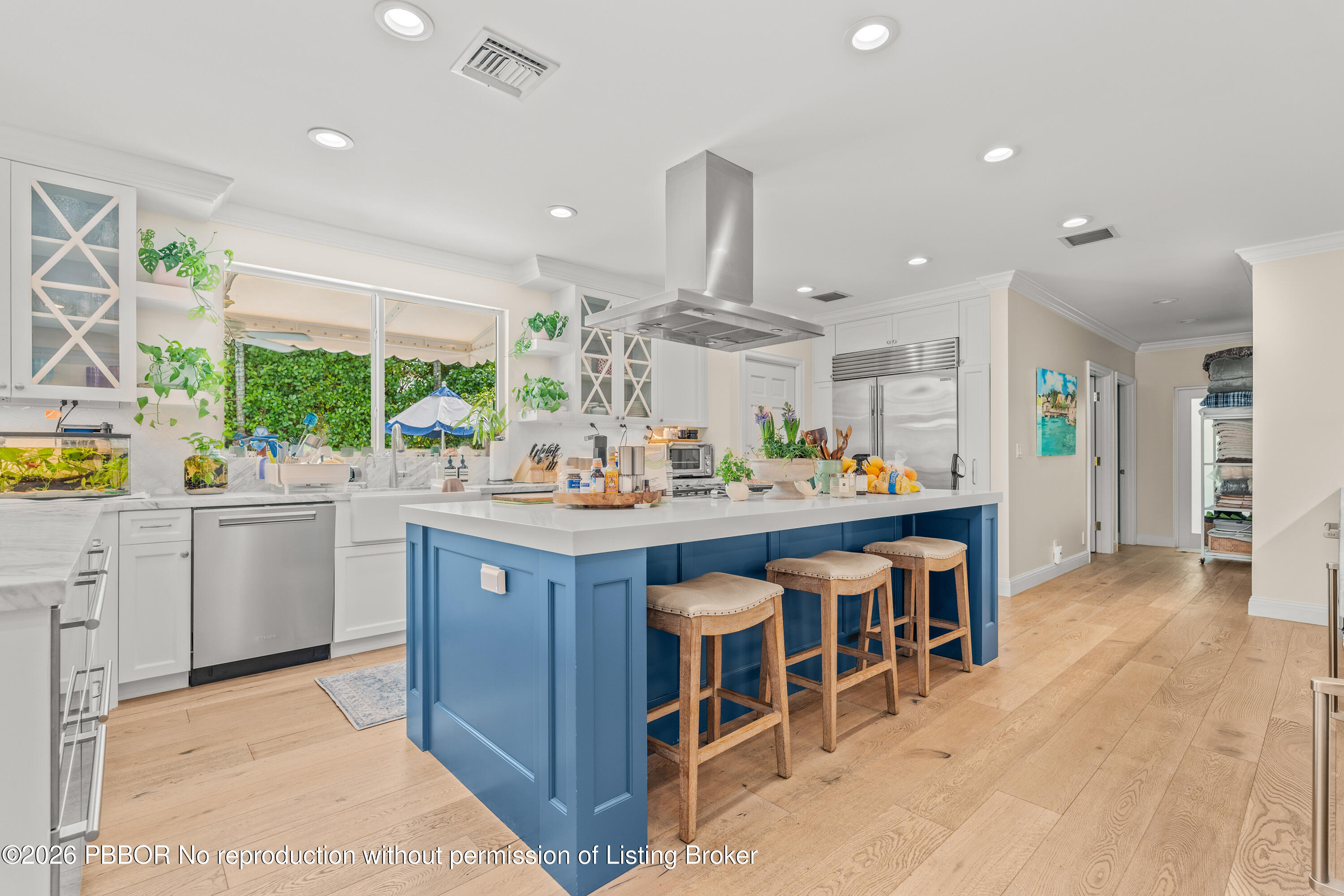 156 Dolphin Road Palm Beach, FL 33480 - Photo 5 of 21 a kitchen with stainless steel appliances kitchen island granite countertop a table chairs sink and cabinets