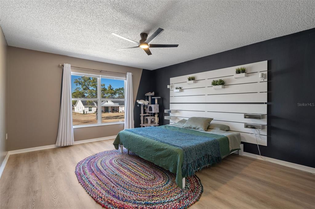 11258 Lomita Wren Road Weeki Wachee, FL 34614 - Photo 23 of 44 a living room with a bed and a chandelier