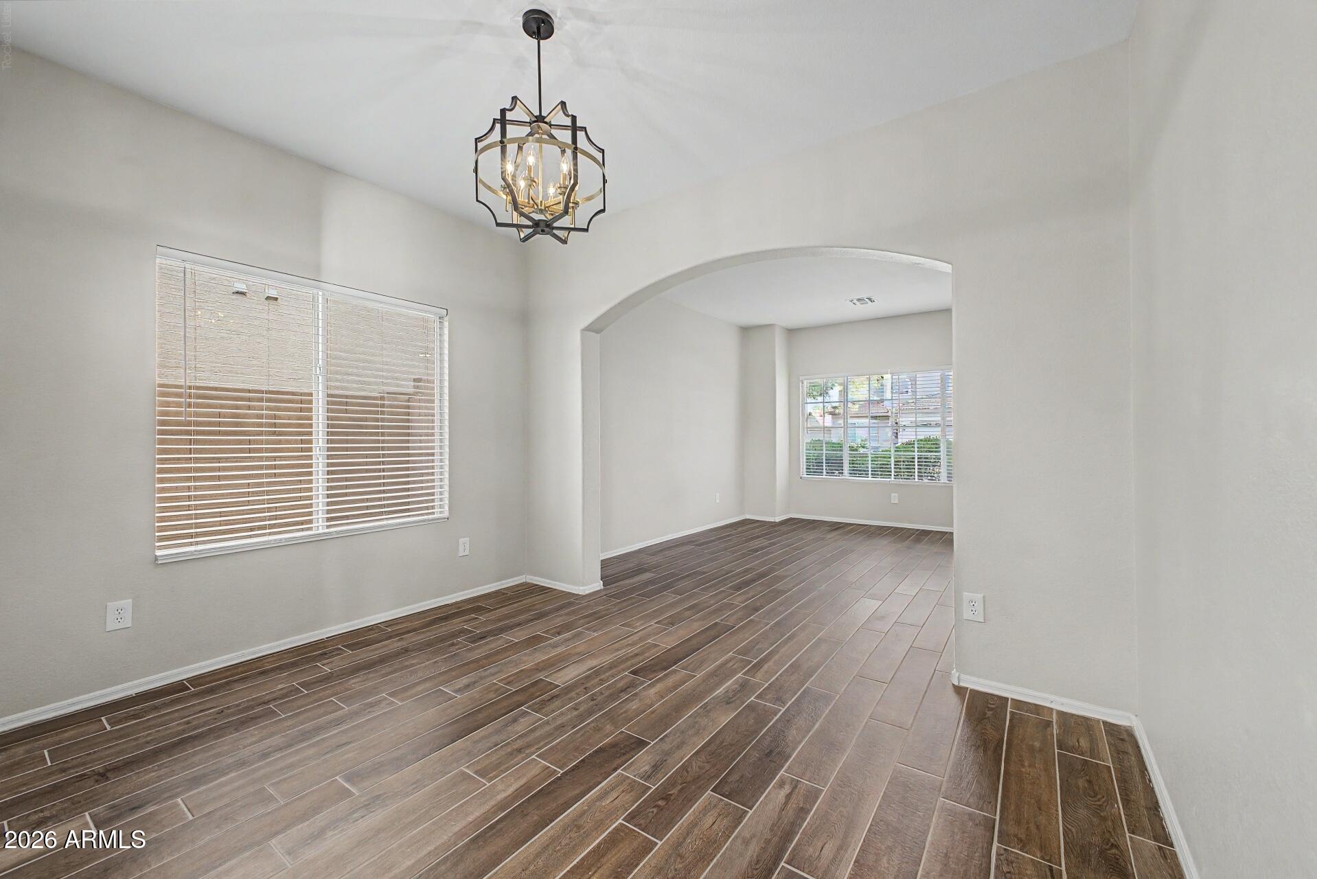 4522 East Rowel Road Phoenix, AZ 85050 - Photo 25 of 61 a view of an empty room with wooden floor and a window