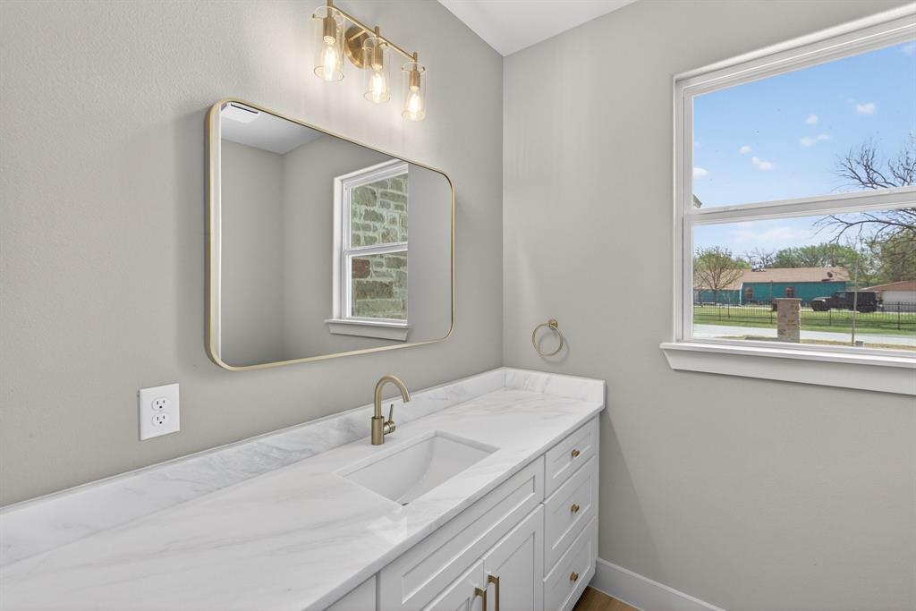 900 Cope Street Mansfield, TX 76065 - Photo 16 of 37 a bathroom with a sink and a mirror