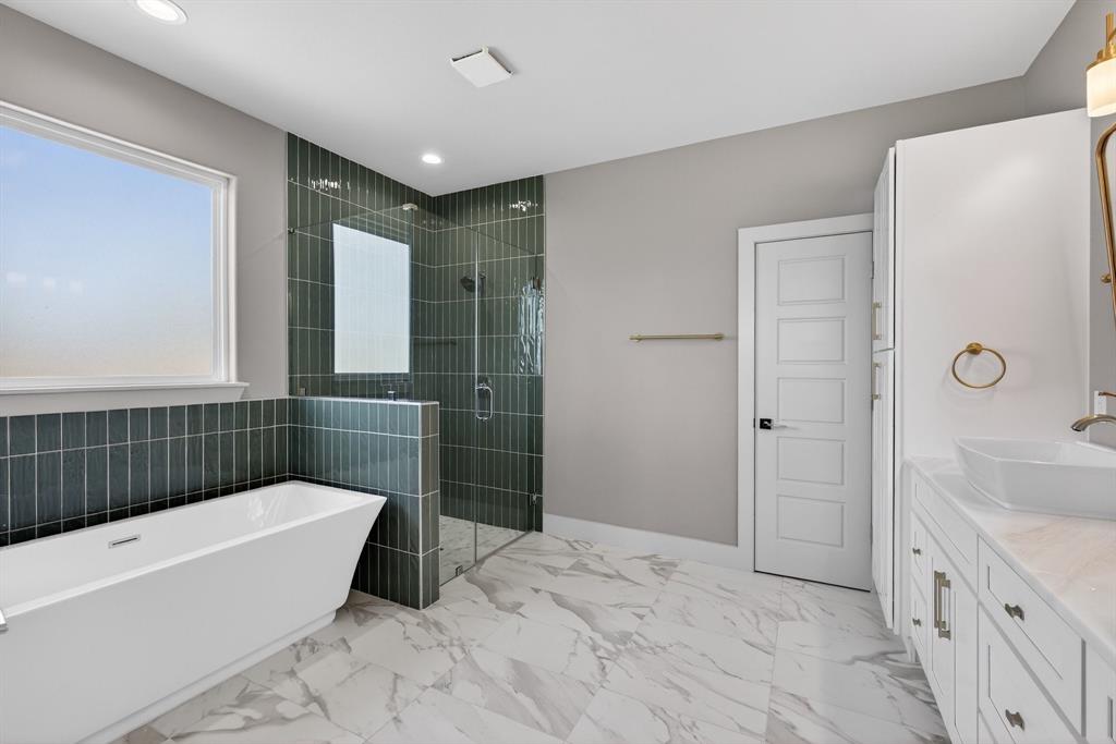 900 Cope Street Mansfield, TX 76065 - Photo 21 of 37 a bathroom with a tub a sink and a large mirror
