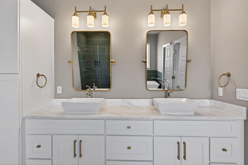 900 Cope Street Mansfield, TX 76065 - Photo 22 of 37 a bathroom with double vanity sinks and a mirror