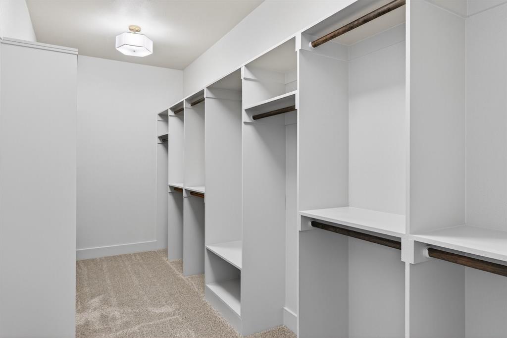 900 Cope Street Mansfield, TX 76065 - Photo 25 of 37 a view of walk in closet with empty racks