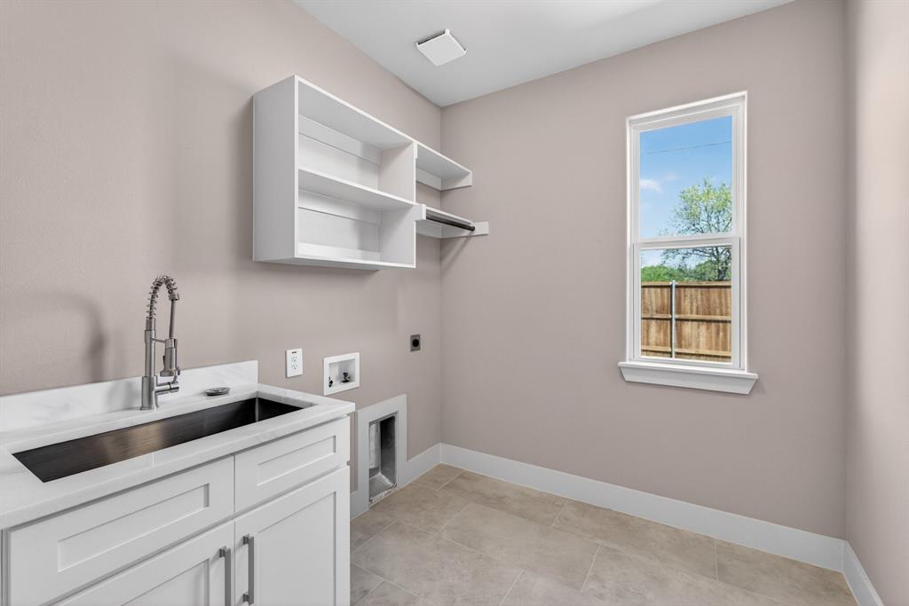900 Cope Street Mansfield, TX 76065 - Photo 27 of 37 a kitchen with a sink cabinets and a window