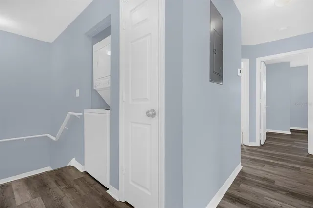 a view of a hallway with wooden floor and staircase