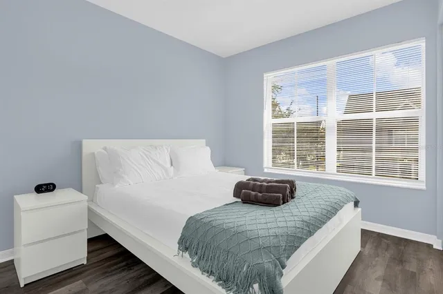 a bedroom with a bed and a window