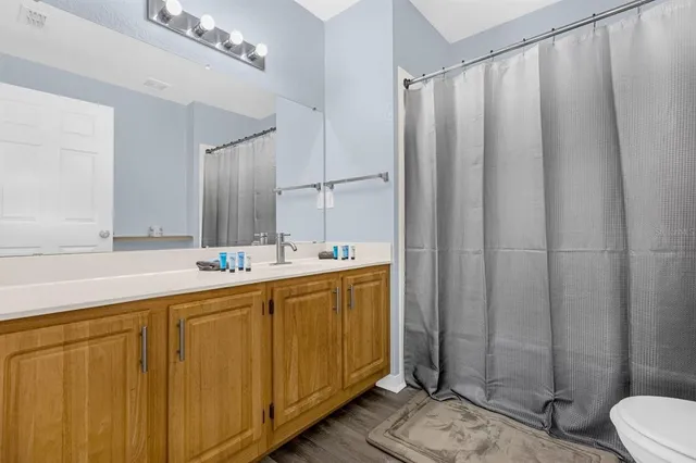 a bathroom with a double vanity sink and mirror
