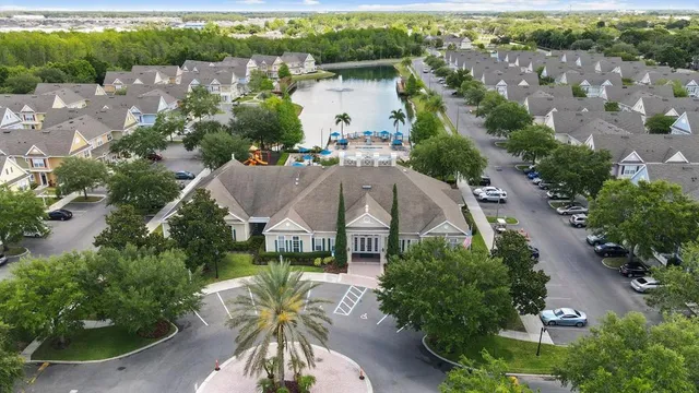an aerial view of a house with outdoor space and lake view